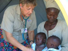 Volunteer nurse Marie Davis, with Medical Teams International, caring for children living in the camps for displaced families in Uganda.
