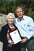 President George W. Bush presents Nealedene Hoch with the President's Volunteer Service Award in Naples, Fla., April 23, 2004.  Hoch is an active volunteer with Keep Collier Beautiful, helping to lead cleanup and education activities.
