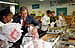 President George W. Bush and Laura Bush help volunteers pack food during their visit to the Capital Area Food Bank in Washington, D.C., Thursday, Dec. 19. "More Americans need to volunteer. There are ways to do so. The USAFreedomCorps.gov on the web page is the place to look," said the President in his remarks. "You can call 1-877-USA-CORPS and find out ways that you can help. If you are interested in being a part of feeding those who hunger, this is a great place to come to."