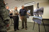 President George W. Bush is briefed on the Midwest flooding by Dick Hainje, Regional Administrator for the Federal Emergency Management Agency, during a visit Thursday, June 19, 2008, to Cedar Rapids, Iowa. The President spent the day touring the devastation left in the wake of the flooding Cedar and Iowa rivers.
