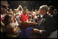 President George W. Bush greets members of the Veterans of Foreign Wars and their family members following his address Wednesday, Aug. 20, 2008, at the VFW National Convention in Orlando, Fla., where President Bush thanked the members of the VFW for their work on behalf of America's veterans. White House photo by Eric Draper