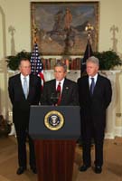 President George W. Bush announces a nationwide charitable fundraising effort to be led by former President George H.W. Bush, left, and former President Bill Clinton to aid victims of last week's earthquake and tsunamis in South Asia in the Roosevelt Room, Monday, January 3, 2005.