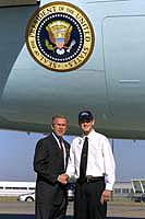 President George W. Bush met Dean Claussen upon arrival in Davenport, Iowa, on Monday, September 16, 2002. Claussen is a high school junior who works with other young people to help those in need through the Scott County 4-H Council. 