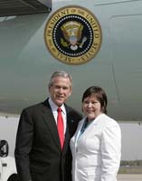 President George W. Bush presented the President’s Volunteer Service Award to Michelle Cornellier upon arrival at the airport in Charlotte, North Carolina, on Thursday, April 6, 2006.  Cornellier is a volunteer with the Army Reserve Family Readiness Program.  To thank them for making a difference in the lives of others, President Bush has met with more than 480 individuals around the country, like Cornellier, since March 2002.
