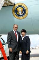 President George W. Bush met Esther Ford upon arrival in Miami, Florida, on Friday, August 27, 2004.  Ford, an American citizen originally from Cuba, is an active volunteer with the Salvation Army and recently returned from a week in Lee County, Florida, where she helped to serve 3,000 meals in three days to victims of Hurricane Charley.
