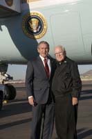 President George W. Bush presented the President’s Volunteer Service Award to Father William Mitchell, 82, upon arrival in Phoenix, Arizona, on Monday, November 28, 2005.  Mitchell is a volunteer with Arizona Project Challenge.   To thank them for making a difference in the lives of others, President Bush has met with over 450 individuals around the country, like Mitchell, since March 2002.