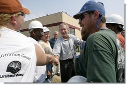 President George W. Bush greets construction workers outside the Folgers Coffee plant in in New Orleans, La., Tuesday, Sept. 20, 2005. White House photo by Eric Draper