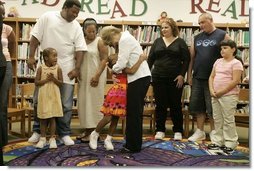 Laura Bush embraces a child Thursday, Sept. 8, 2005 of one of the families from New Orleans, displaced last week as a result of Hurricane Katrina, during a meeting at the Greenbrook Elementary School in DeSoto County, Miss. Greenbrook Elementary School has enrolled the most displaced students among the DeSoto County schools in Mississippi.  White House photo by Krisanne Johnson