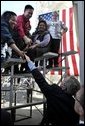 President George W. Bush greets employees at Ruiz Foods after speaking on housing and the economy in Dinuba, Calif., Wednesday, Oct. 15, 2003.  White House photo by Eric Draper