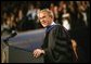 President George W. Bush imparts some light-hearted audience to the graduating students at the Louisiana State University Commencement in Baton Rouge, La., Friday, May 21, 2004. "As you enter professional life, I have a few other suggestions about how to succeed on the job. For starters, be on time. It's polite, and it shows your respect for others. Of course, it's easy for me to say," said the President. "It's easy for me to be punctual when armed men stop all the traffic in town for you."  White House photo by Eric Draper