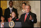 President George W. Bush gestures as he congratulates the 2007 Presidential Scholars Monday, June 25, 2007 in the East Room of the White House, and highlights the need to reauthorize the No Child Left Behind Act this year. White House photo by Joyce N. Boghosian