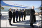 President George W. Bush, joined by Mrs. Laura Bush, stands outside Air Force One as he addresses his remarks in honor of Veterans Day, Tuesday, Nov. 11, 2008 upon the President's arrival at John F. Kennedy International Airport in New York. President Bush introduced military personnel representing the five branches of the armed services, who traveled with him aboard AF-1, honoring their service, from left are, U.S. Navy Chief Petty Officer Shenequa Cox of Dallas, Texas; U.S. Coast Guard Petty Officer First Class Christopher O. Hutto of Homer, Alaska; U.S. Army National Guard SSgt Michael Noyce-Merino of Melrose, Montana; U.S. Air Force Senior Airman Alicia Goetschel of Warrensburg, Mo., and U.S. Marine Corps Sgt. John Badon of Lufkin, Texas.  White House photo by Eric Draper