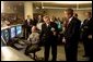 President George W. Bush listens to Hermann Grunder, Director of the Argonne National Laboratory, during a tour of the research facilities with Homeland Security Director Tom Ridge, Secretary of Energy Spencer Abraham and Speaker of the House of Representatives Dennis Hastert, R-IL., in Argonne, IL., July 22. Sponsored by the Dept. of Energy and operated by the University of Chicago, the laboratory is combating terrorism through innovative projects such as detectors for neutrons, biological and chemical agents and developing an emergency response system that coordinates various technologies.  