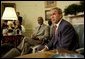 President George W. Bush and United Nations Secretary General Kofi Annan talk with the media during a meeting in the Oval Office Monday, July 14, 2003. They discussed President Bush's recent trip to Africa, and issues concerning Liberia and Iraq.  White House photo by Paul Morse