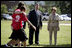 Mrs. Laura Bush and Mike Gottfried, CEO of Team Focus, watch Team Focus participants run a relay race Thursday, June 21, 2007, in Mobile, Ala., during a visit to Team Focus's National Leadership Camp, as part of Helping America’s Youth initiative. Team Focus is a faith-based, nonprofit organization devoted to improving the lives of young men, ages 10-18, without fathers in their lives.