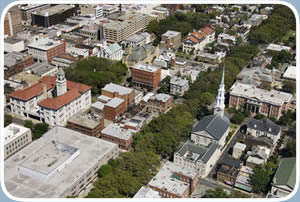 The center of a small town is shown in this aerial view. A church and its steeple are visible.