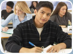 Students work at their desks in a classroom.