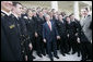 President George W. Bush meets with members of the U. S. Naval Academy football team, after presenting the team with the Commander-In-Chief trophy at the White House, Monday, April 2, 2007. White House photo by Eric Draper