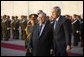 President George W. Bush walks with Iraq's President Jalal Talabani folowing his review of an honor guard upon his arrival Sunday, Dec. 14. 2008 to the Salam Palace in Baghdad, where President Bush met with Iraq's leadership. White House photo by Eric Draper