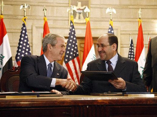President George W. Bush and Iraqi Prime Minister Nuri al-Maliki shake hands following the signing of the Strategic Framework Agreement and Security Agreement at a joint news conference Sunday, Dec. 14, 2008, at the Prime Minister's Palace in Baghdad. President Bush said, " The agreements represent a shared vision on the way forward in Iraq." White House photo by Eric Draper