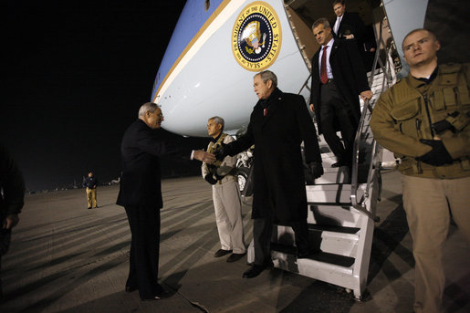 President George W. Bush is greeted as he deplanes Air Force One Monday, Dec. 15, 2008, after arriving in the pre-dawn hours in Afghanistan. The President visited with troops at Bagram Air Base, thanking them for their service and telling them, "I am proud to be with brave souls serving the United States of America." White House photo by Eric Draper