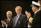 President George W. Bush glances at Admiral Mike Mullen, Chairman of the Joint Chiefs of Staff, as they stand with U.S. Secretary of Defense Robert Gates during a military tribute Tuesday, Jan. 6, 2009, at Ft. Myer in Arlington, Va. White House photo by Joyce N. Boghosian