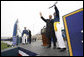 President George W. Bush and a graduate of the United States Air Force Academy wave to family and friends in the audience Wednesday, May 28, 2008, during graduation ceremonies for the Class of 2008 in Colorado Springs. The class of 1,012 cadets is the 50th to graduate from the Academy. White House photo by Eric Draper