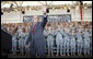 President George W. Bush waves to the troops at Fort Campbell, Ky., Tuesday, Nov. 25, 2008, after being introduced on stage during a Thanksgiving visit. Said the President, "Over the past seven years, folks from this base have done exactly what they were trained to do." "You have taken the battle of the terrorists overseas so we do not have to face them here in the United States. You have helped counter the hateful ideology of tyranny and terror with a more hopeful vision of justice and liberty. You're part of the great ideological struggle of our time. With the soldiers of Fort Campbell out front, the forces of freedom and liberty will prevail." White House photo by Eric Draper