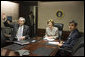 Mrs. Laura Bush acknowledges the Ladies in White during a video teleconference Thursday, Oct. 16, 2008, in the Situation Room of the White House. Mrs. Bush is joined by U.S. Secretary of Commerce Carlos Gutierrez, waving left, and interpreter Manuel Quiroz. Mrs. Laura Bush conveyed her continuous commitment, and that of the President, to support the Cuban people's aspirations for freedom. White House photo by Joyce N. Boghosian