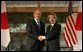 President George W. Bush and Prime Minister Junichiro Koizumi of Japan, shake hands Wednesday, Nov. 16, 2005, prior to their meeting at the Kyoto State Guest House in Kyoto, Japan.  White House photo by Paul Morse