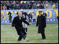 President George W. Bush playfully kicks a 15-yarder from around the 30 yard line Saturday, Dec. 6, 2008, as he took the field at Philadelphia's Lincoln Financial Field for the 2008 Army-Navy game. The Commander in Chief was headed to midfield for the coin toss, when he spotted the ball on the tee and went for it.  White House photo by Eric Draper