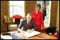 With Laura Bush looking on, President George W. Bush signs a proclamation designating February as American Heart Month in the Oval Office, Feb. 1, 2005. The proclamation encourages awareness of factors leading to heart disease such as smoking, high cholesterol, lack of exercise, obesity and diabetes.  White House photo by Susan Sterner