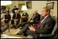 President George W. Bush talks with the press during a meeting with congressional leaders in the Oval Office Friday, March 21, 2003. Pictured with the President are, from left, House Minority Leader Nancy Pelosi, D-Calif., Speaker of the House Dennis Hastert, R-Ill., and Vice President Dick Cheney.   White House photo by Paul Morse