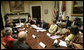 President George W. Bush and Laura Bush host a meeting on World AIDS Day in the Roosevelt Room at the White House, Friday, Dec. 1, 2006. As this World AIDS Day marks the 25th anniversary of the discovery of the HIV virus, President Bush said, �It is a day for the world to recognize the fact that there are 39 million people living with HIV/AIDS, and a day to remember the fact that 25 million people have died of AIDS.�  White House photo by Eric Draper