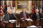 President George W. Bush is joined by President Hamid Karzai of Afghanistan during a video teleconference with U.S. Provincial Reconstruction team leaders, National Guard Agriculture Development team representatives and Afghan governors Friday, Sept. 26, 2008, in the Roosevelt Room at the White House. U.S. Secretary of Defense Robert Gates is seen at right. White House photo by Eric Draper