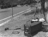 Theodor Horydczak, photographer.  Theodor Horydczak lying on ground with camera