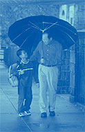 Image of father and son walking in the rain