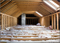 Photo of an attic with insulation blown into the floor. Copyright iStockphoto.com/Oktay Ortakcioglu.