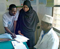 Photo: Staff from the Zanzibar Malaria Control Program (standing) and a clinical officer from a peripheral health facility (seated).