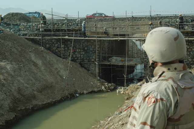 Stone masons construct a stone culvert and bridge on the road from Kabul to Bagram, Afghanistan.  