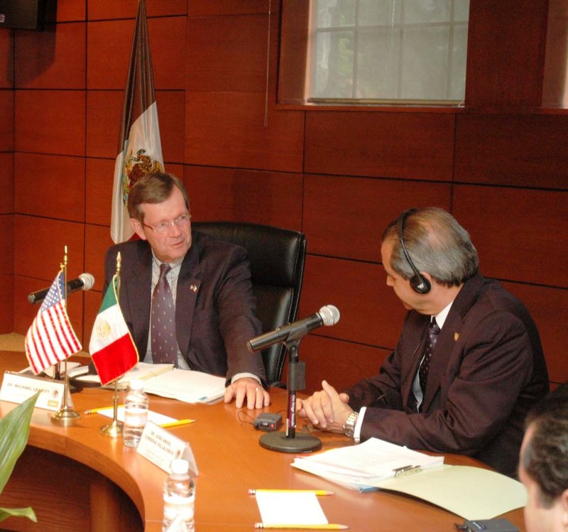 Secretary Leavitt speaking to Secretary Cordova during a bi-lateral meeting between U.S. and Mexican health officials.