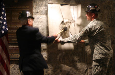 A mortar sheet is smashed to unveil plaque