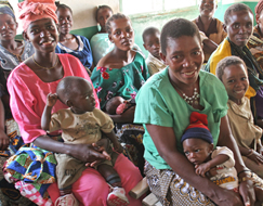 Photo of mothers and their children waiting for antenatal care services in a PMI-supported clinic in Tanzania. 