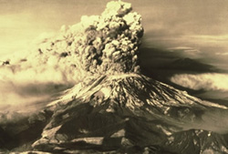Sepia tone photo of the mounting during the eruption, large plume of ash hanging above the mountain.