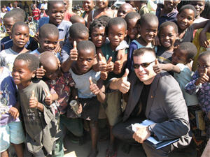 John Mallos with children in Africa