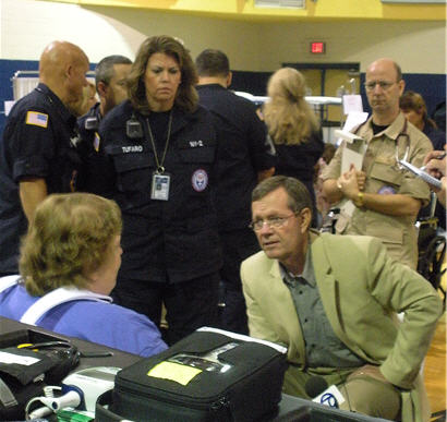 Secretary Leavitt with a patient and medical workers at the shelter.