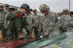 Marine Sgt. Mark Warner (left), technical rescue technician, Chemical Biological Incident Response Force, II Marine Expeditionary Force, shows an Army soldier, SPC. Dale Sloniger (right) from 1st Heavy Brigade Combat Team, 3rd Infantry Division, how to safely cut through a windshield. BCT 1-3 is the first active-duty Army unit tasked with the mission of chemical, biological, radiological, nuclear, and high-yield explosive consequence management. 