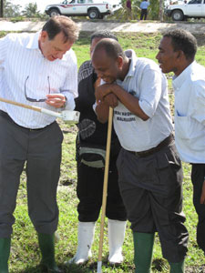 Photo of Dr. Bernard Nahlen reviewing mosquito larval control activities with Ms. Khadija Kannady, project coordinator, and two staff from the Urban Malaria Control Programme (UMCP) in Dar es Salaam, Tanzania.