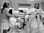 Apollo 10 commander pats stuffed Snoopy.