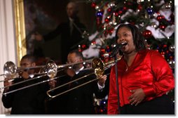 A vocalist with Sweet Heaven Kings entertains in the East Room of the White House Monday, Dec. 8, 2008, during the 2008 Children's Holiday Reception and Performance hosted by President George W. Bush and Mrs. Laura Bush. The Sweet Heaven Kings is the premier brass band at the United House of Prayer in Anacostia, Washington, D.C.  White House photo by Eric Draper